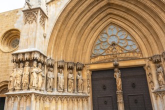 Statues of saints decorating the richly adorned main entrance of tarragona cathedral, a stunning