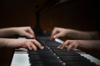 Hands of a young pianist playing on the keyboard of a Steinway & Sons grand piano, Stuttgart,