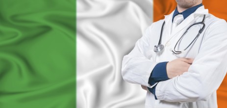 Ireland health care concept. Male doctor on Ireland flag. Doctor with crossed arms on Ireland flag
