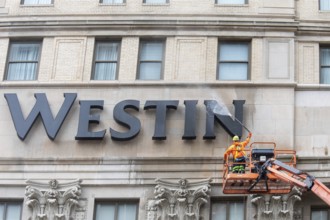 Detroit, Michigan - A worker uses a high-pressure water spray to clean the exterior of the