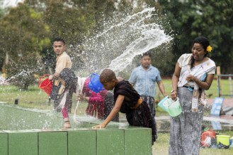 NAMSAI, INDIA.- APRIL 16: Devotees celebrate the vibrant Sangken Festival by pouring water over