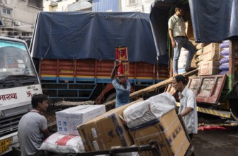 GUWAHATI, INDIA - MAY 1: Labourers carries goods in a wholesale market, in Guwahati, India, on May