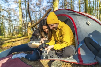 Couple enjoying a moment together while reviewing mushroom photos on a digital camera during a