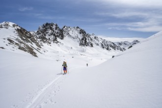 Ski tourer in mountain landscape with snow, ascent to Grialetsch Scharte, Bündner Haute Route,