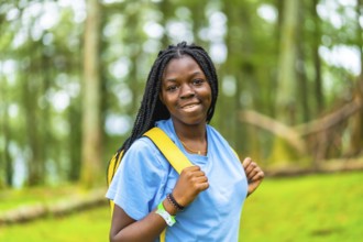 Horizontal close-up portrait of cheerful young african female hiker