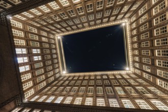 Impressive perspective of the Chilehaus at night, illuminated entrance and brick façade, Hamburg,