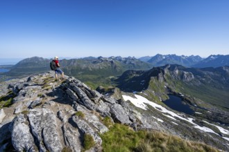 View of mountains and fjord landscape, mountaineers at the summit of Rundfjellet, Lake
