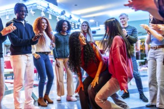Young people having fun dancing at the bowling alley, enjoying their weekend together with energy
