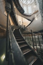Architectural view of a wooden staircase under a net at a lofty height, old Elbe tunnel, Hamburg,
