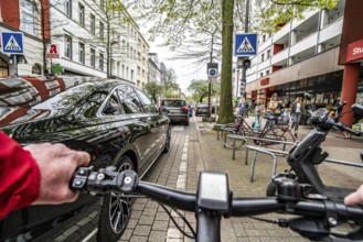 Cycling in the city, inner-city street, cycle lane, bicycles have priority, two-lane traffic with