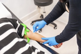 Woman lying on stretcher ready for blood extraction in a baldness treatment clinic