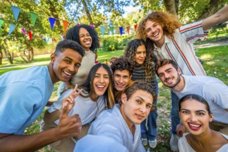 Frontal personal perspective view of happy young multi-ethnic students taking selfie celebrating