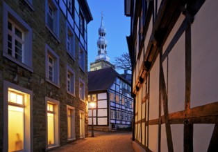 Mariengasse in the old town with half-timbered houses and St Peter's Church in the evening, Soest,