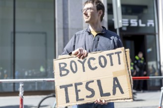 Berlin, Germany - 5 April 2025: People demonstrate against Tesla owner Elon Musk in front of a