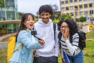 Three cool multi-ethnic students talking selfie with wearable camera and tripod