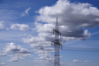 High-voltage pylon in front of a cloudy sky, symbolic image of infrastructure, Germany, Europe