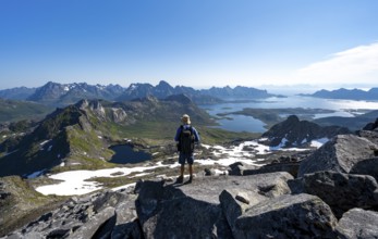 View of mountains and fjord landscape, mountain panorama, mountaineer at the summit of Rundfjellet,