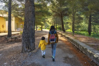 Mother and son enjoying a peaceful walk in the natural setting of the sanctuary of fontcalda in