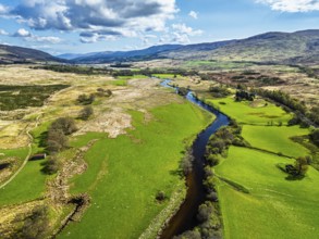 Farms and Mountains over River Dochart and Road A85 from a drone, Perthshire, Scotland, UK