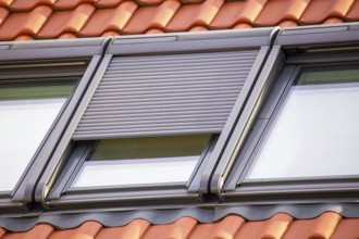 Close-up of a roof window with roller shutter