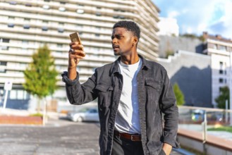 African man looking to online maps to find a direction in the city