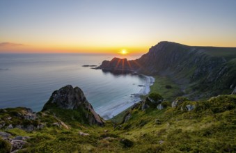 View of coastal landscape at sunset, cliffs and summit of Måtind or Måtinden, Høyvika beach and