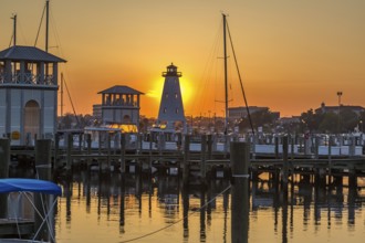 Setting sun behind lighthouse at the Small Craft Harbor in Gulfport, Mississippi, USA, North