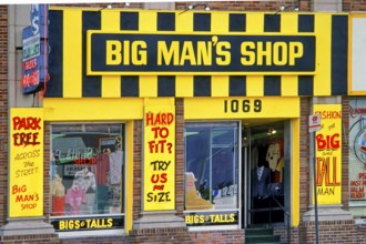 Facade of a plus size shop with eye-catching yellow and black neon sign, Big Man's Shop, retail,