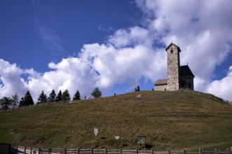 Hikers in front of St. Vigilius church, Vigilius on the yoke, faith trail, near Lana, South Tyrol,