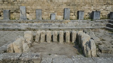 Several upright stones in an ancient archaeological excavation, ancient well house, Kamiros,