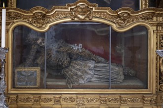 Magnificent glass shrine with decorated bones of a catacomb saint, Basilica of St Mauritius,