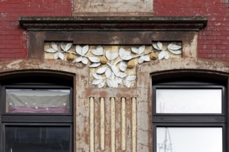 Facade decoration on a Wilhelminian style house for renovation, branches with pears, detail,
