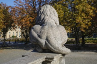 Resting lion made of granite on the terraced base of the equestrian statue of Emperor Wilhelm I on