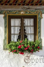 Typical Lüftlmalerei around window with geraniums, Wallgau, Werdenfelser Land, Upper Bavaria,