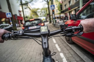Cycling in the city, inner-city street, cycle lane, bicycles have priority, two-lane traffic with