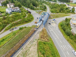 Railway line and train on a bridge over a road crossing, track construction, rail delivery for
