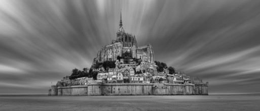 Impressive view of Mont Saint-Michel in black and white, surrounded by dramatic clouds, Le