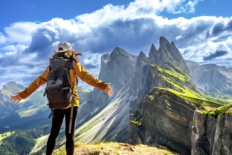 Backpacker enjoying breathtaking panorama of the odle mountain range during summer adventures in