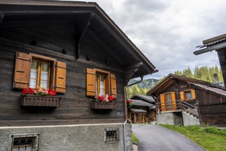 Traditional wooden houses in the mountain village of Fionnay, Val de Bagnes, Valais, Western Alps,