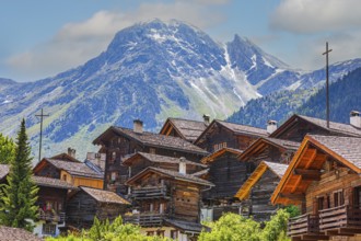Nested old wooden houses, behind the summit of the Scex de Marenda mountain, historic village