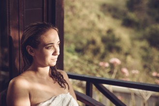 Woman relaxing in natural surroundings in sunlight, Nusa Penida, Bali, Indonesia, Asia