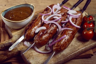 Fried sausages, in English with bacon, for grilling, on a cutting board, top view, no people