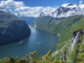 Panorama aerial view of the Geirangerfjord on a sunny spring day, waterfall Gjerdefossen, boats on