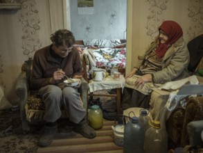 Varvara, 85, and her son Leonid, 56. Leonid looks after his mother, who is in need of care. She