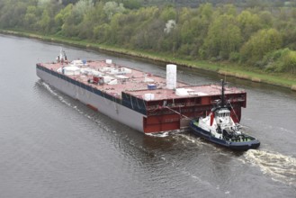 Tugboat pulling ship, ship component Lse Casco Project through the Kiel Canal to Papenburg,