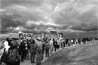 Tourists visit Stonehenge under an overcast sky, Wiltshire, England, Great Britain
