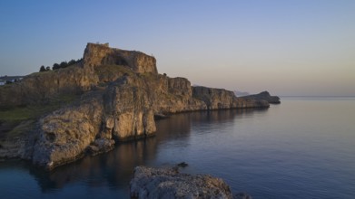 Drone shot, first morning light, Lindos, Acropolis of Lindos, Picturesque castle on a cliff