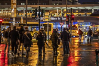 Pedestrian, in rainy weather, at a traffic light, pedestrian crossing, at the main railway station