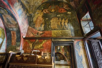 Historical painting with religious themes and figures on a wall in an Orthodox church, scenes from