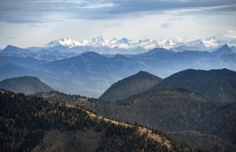View of the Alpine foothills and main Alpine ridge with snow-covered peaks, summit of the Hohe